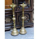 A PAIR OF LARGE ECLESIASTICAL BRASS CANDLESTICKS. H.80cms.