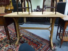 AN ANTIQUE OAK TOPPED CENTRE TABLE WITH BENTWOOD BASE IN THE MANNER OF THONET. 110 x 55 x 76cms.