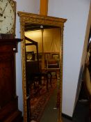 AN ANTIQUE TALL GILT FRAME PIER MIRROR WITH MOULDED SWAG AND URN DECORATION. 189 x 72cms.