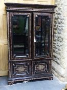 A COLONIAL MOORISH STYLE HARDWOOD AND INLAID GLAZED DISPLAY VITRINE CABINET. W.112 x H.175cms.