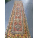 AN ANTIQUE PERSIAN HAMADAN RUNNER.