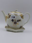 AN EARLY WORCESTER TEAPOT AND COVER DECORATED WITH GILDED SPRAYS AND BLUE PETALS TOGETHER WITH A