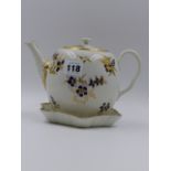 AN EARLY WORCESTER TEAPOT AND COVER DECORATED WITH GILDED SPRAYS AND BLUE PETALS TOGETHER WITH A