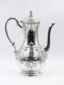 A VICTORIAN EMBOSSED SILVER HALLMARKED COFFEE POT, DATED 1859 SHEFFIELD, APPROXIMATE HEIGHT 27cms,