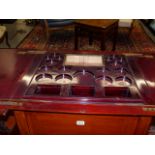 AN EDWARDIAN MAHOGANY DRINKS CABINET WITH FOLD OVER TOP AND RISING CENTRE BOTTLE SUPPORT.