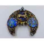 AN ARTS AND CRAFT WHITE METAL AND ENAMELLED BROOCH. ORIGINALLY A HAIRSLIDE, THE CENTRE PANEL WITH