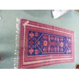 A TURKISH TRIBAL RUG 204 x 113cms. TOGETHER WITH AN ORIENTAL RUG OF BOKHARA DESIGN.