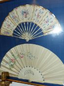 TWO ANTIQUE CARVED AND PAINTED FANS MOUNTED IN A BESPOKE SHADOW B OX FRAME EACH WITH PIERCED WORK