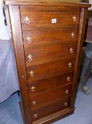 A LATE VICTORIAN OAK WELLINGTON CHEST OF SEVEN DRAWERS WITH SIDE LOCKING BARS 52 X 112 CM