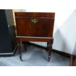 A WM.IV.MAHOGANY CELLARETTE ON STAND IN THE MANNER OF GILLOWS RETAINING ORIGINAL TIN LINER. W.