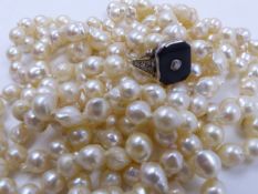 A ROPE STRAND OF KNOTTED BAROQUE PEARLS, APPROXIMATE LENGTH 184cms, TOGETHER WITH A PRECIOUS