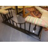 A LARGE WROUGHT IRON CLUB FENDER WITH UPHOLSTERED ENDS AND DROP CENTRE. W.165cms.