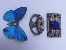 A LARGE SILVER STAMPED BUTTERFLY WING BROOCH SET WITH OPALS, TOGETHER WITH TWO FURTHER WHITE METAL