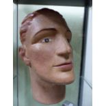 AN EARLY 20th.C.PLASTER MANNEQUIN HEAD WITH WELL PAINTED FEATURES.
