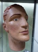 AN EARLY 20th.C.PLASTER MANNEQUIN HEAD WITH WELL PAINTED FEATURES.