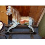 AN EDWARDIAN PAINTED ROCKING HORSE ON TRESTLE BASE. H.103cms TO THE EAR.