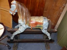 AN EDWARDIAN PAINTED ROCKING HORSE ON TRESTLE BASE. H.103cms TO THE EAR.