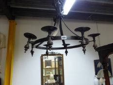 A WROUGHT IRON CHANDELIER WITH EIGHT CANDLE HOLDERS.