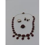 A VICTORIAN BOHEMIAN ROSE CUT GARNET NECKLACE WITH DOUBLE CLUSTER DROPS FINISHED WITH A GARNET SET