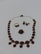 A VICTORIAN BOHEMIAN ROSE CUT GARNET NECKLACE WITH DOUBLE CLUSTER DROPS FINISHED WITH A GARNET SET