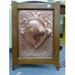 AN INTERESTING ARTS AND CRAFTS COPPER REPOUSSE PANEL WITH ARMORIAL CREST AND IN OAK FRAME. 48 x