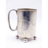 A VICTORIAN SILVER FOOTED MUG DATED 1882, TOWN MARK BIRMINGHAM. ENGRAVED WITH A DESIGN OF VEGETABLES