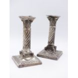 A PAIR OF VICTORIAN SILVER COLUMN CANDLESTICKS ORNATELY DECORATED WITH A RAM'S HEAD AND SWAG DESIGN.