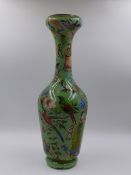 A DECELOMANDA GREEN GLASS BOTTLE VASE. 40cms. HIGH.