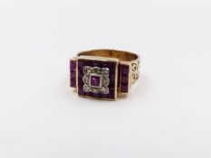 A PRECIOUS YELLOW METAL RUBY AND DIAMOND RING. EMERALD CUT RUBIES ARE INSET INTO A GEOMETRIC SETTING