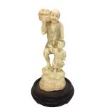 C19th Chinese Okimono on carved wooden base, man & child, he carrying basket of fruit on his