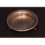 Late 20th century silver circular pin dish raised on three paw feet with moulded rim, Birmingham