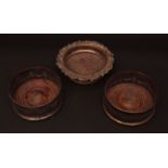 Pair of electro-plate on copper circular coasters with pierced swag moulded borders, treen insets,