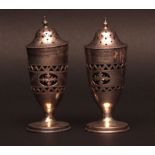 Pair of George V silver salt sifters with blue glass liners and pierced borders and pull off covers,