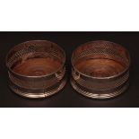 Pair of electro-plated circular coasters with gadrooned rims and pierced central panels