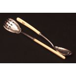 Pair of Victorian ivory handled salad servers, each with waisted bowls, one with cut tines and