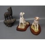 Wild Track figures: seated Dalmatian, together with a further seated dog and further model of wolf