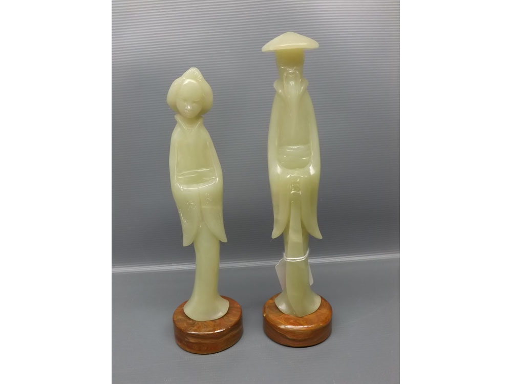 Two oriental green composition figures: master and geisha girl raised on stone plinths, 9 1/2" tall