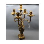 20th century gilt metal four-branch candelabra with rococo style detailing, terminating in a