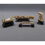 Group of four items of Chinese ivory, all fitted on wooden stands, to include a carved dragon, a