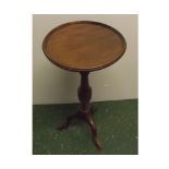 20th century mahogany wine table, with circular top and turned columns, terminating on a tripod