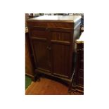 20th century mahogany two-door record cabinet with compartmentalised interior, raised on claw and