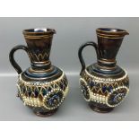 Pair of Royal Doulton stoneware ewers with raised bees detail with a cut diamond design, impressed