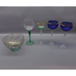Three coloured glass and gilded hock glasses, with clear stems, together with non-matching glass and