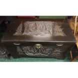 20th century Malaysian heavily carved camphorwood chest, with carved shipping scene panel to lid