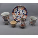 Imari decorated plate and a 19th century Imari coloured shaped mug with broken handle, together with