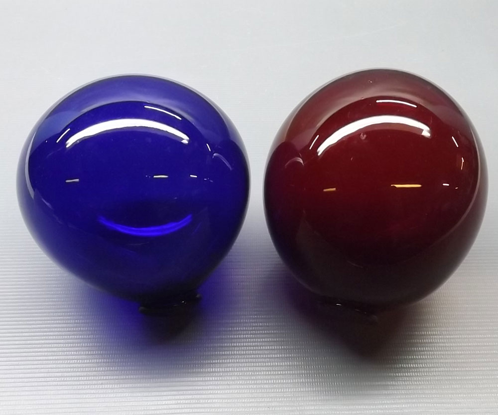 Two coloured glass decorative balls, 5" diameter