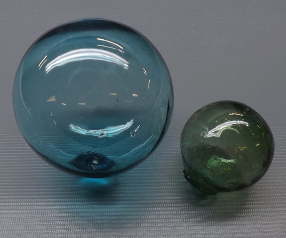 Two decorative coloured various sized glass balls