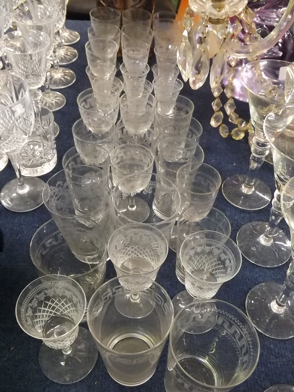 Collection of 34 early 20th century engraved glasses to include sherry glasses, tumblers etc