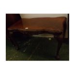 Reproduction mahogany coffee table, with shaped edge and carved frieze, raised on four pad feet with