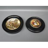 Two various pot lids, each in ebonised socles, 3" and 4" diameter